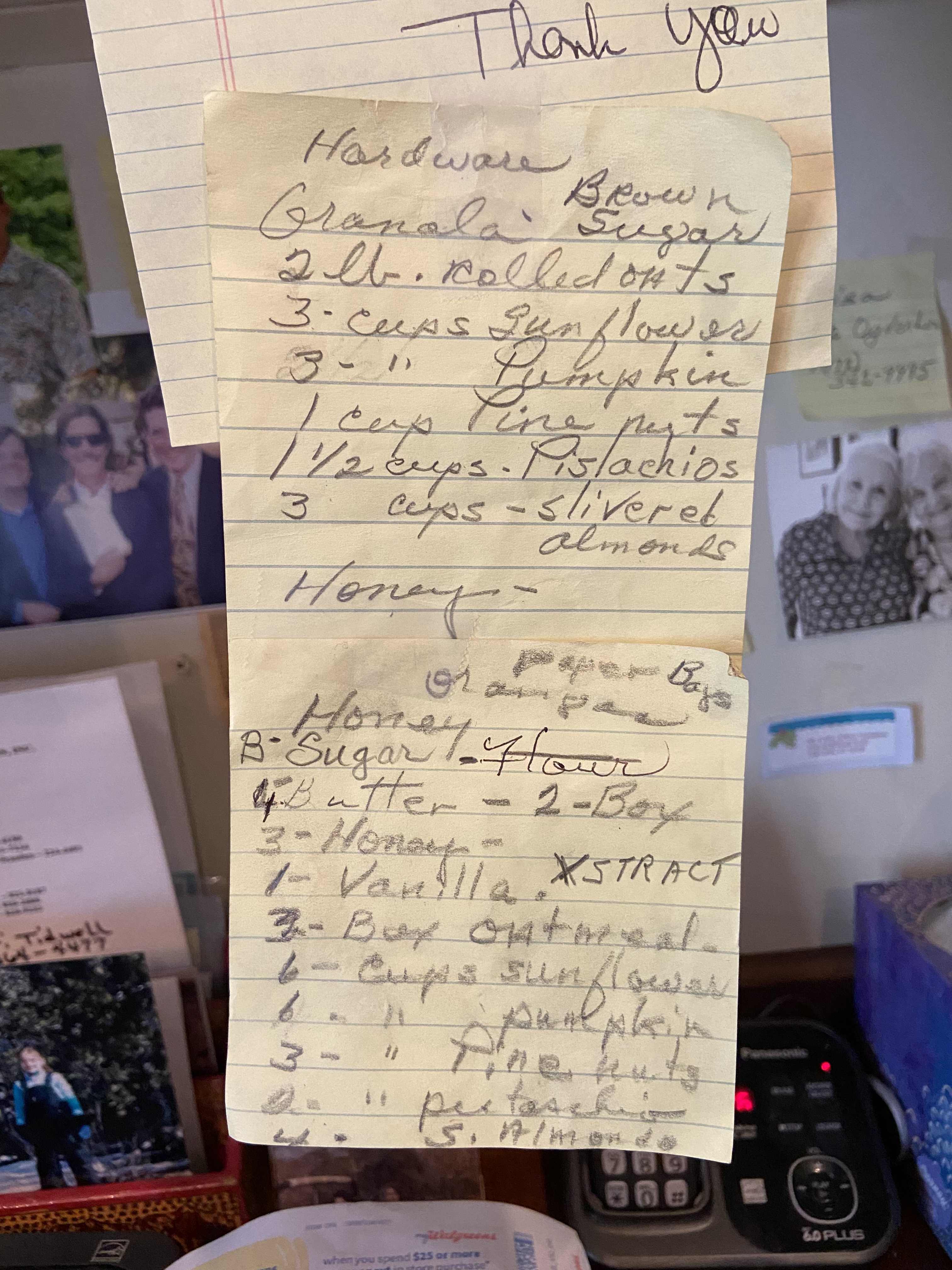 A handwritten granola recipe pinned to a kitchen bulletin board